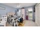 This is a cozy bedroom with lots of natural light, a ceiling fan, and a view to the outside at 245 Edenwylde Ct, Hampton, GA 30228