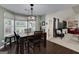 Inviting dining area boasts a wooden table set, large windows, and stylish chandelier at 245 Edenwylde Ct, Hampton, GA 30228