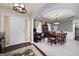 Elegant dining room with large table, crown molding, stylish chairs, and sophisticated décor at 245 Edenwylde Ct, Hampton, GA 30228