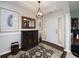 Welcoming foyer with hardwood floors, stylish rug, decorative mirror, and ample natural light at 245 Edenwylde Ct, Hampton, GA 30228