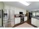 Well-equipped kitchen with stainless steel appliances, white cabinets, and granite countertops at 245 Edenwylde Ct, Hampton, GA 30228