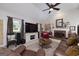 Comfortable living room with fireplace, TV, and windows with lots of natural light at 245 Edenwylde Ct, Hampton, GA 30228