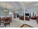 Open-concept living space with dining area, living room, and elegant architectural columns at 245 Edenwylde Ct, Hampton, GA 30228