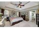 Serene main bedroom featuring a tray ceiling, neutral tones, and a view to the bath at 245 Edenwylde Ct, Hampton, GA 30228