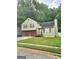Charming home featuring a two-car garage, classic shutters, and a well-maintained front lawn at 35 Hampton Oaks Dr, Hampton, GA 30228