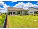 Spacious backyard with lush lawn, stone pathway, privacy fence, and patio seating offers a serene outdoor living space at 326 Elkins Place, Peachtree City, GA 30269