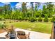 Enjoy this spacious backyard featuring a lush lawn, stone pathway, and seating area perfect for outdoor relaxation at 326 Elkins Place, Peachtree City, GA 30269