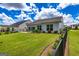 Large backyard featuring a manicured lawn, patio seating, and privacy fence, ideal for outdoor enjoyment and entertaining at 326 Elkins Place, Peachtree City, GA 30269