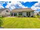 This fenced backyard offers ample green space, a patio with seating, and beautiful landscaping for outdoor relaxation at 326 Elkins Place, Peachtree City, GA 30269