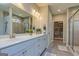 Elegant bathroom featuring a double vanity, tiled shower, and walk-in closet at 326 Elkins Place, Peachtree City, GA 30269