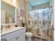 Functional bathroom with a vanity, toilet, and shower with decorative seashell-themed curtain at 326 Elkins Place, Peachtree City, GA 30269