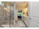 Modern bathroom showcasing a glass shower and double vanity, with a view into the bedroom at 326 Elkins Place, Peachtree City, GA 30269