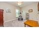 Bright bedroom featuring neutral walls, a ceiling fan, and exercise equipment for a functional space at 326 Elkins Place, Peachtree City, GA 30269