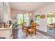 Cozy dining area features a wooden table set, complemented by a bright, adjacent sunroom at 326 Elkins Place, Peachtree City, GA 30269