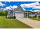 Single-story home with attached two-car garage and well-manicured lawn, showcasing suburban living at 326 Elkins Place, Peachtree City, GA 30269