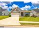 Charming single-story home featuring a well-maintained lawn and an attached two-car garage at 326 Elkins Place, Peachtree City, GA 30269