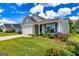 Beautifully landscaped front yard with lush grass, shrubs, and a charming single-story home at 326 Elkins Place, Peachtree City, GA 30269