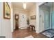 Elegant foyer with hardwood floors, featuring a grandfather clock and decorative accents at 326 Elkins Place, Peachtree City, GA 30269