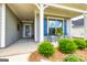 Inviting front porch with seating area, perfect for enjoying the outdoors with decorative blue shutters at 326 Elkins Place, Peachtree City, GA 30269