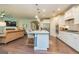 Modern open kitchen with island, bar stools, and stainless steel appliances at 326 Elkins Place, Peachtree City, GA 30269