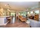 Expansive living room with hardwood floors, modern lighting, and ample seating at 326 Elkins Place, Peachtree City, GA 30269
