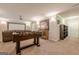 Finished basement with a recreation area, including a projector screen and comfortable seating arrangement at 3502 Village Green Dr, Roswell, GA 30075
