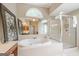 Elegant bathroom boasts a soaking tub, separate shower, dual vanities, and decorative mirrors at 3502 Village Green Dr, Roswell, GA 30075