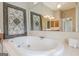 Elegant bathroom boasts a soaking tub, separate shower, dual vanities, and decorative mirrors at 3502 Village Green Dr, Roswell, GA 30075