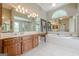 Elegant bathroom boasts a soaking tub, separate shower, dual vanities, and decorative mirrors at 3502 Village Green Dr, Roswell, GA 30075