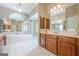 Elegant bathroom boasts a soaking tub, separate shower, dual vanities, and decorative mirrors at 3502 Village Green Dr, Roswell, GA 30075