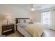 Cozy bedroom featuring natural light, ceiling fan, neutral walls, and hardwood flooring at 3502 Village Green Dr, Roswell, GA 30075