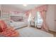 Charming bedroom featuring a white bunk bed, delightful decor, and a cozy pink and white color scheme at 3502 Village Green Dr, Roswell, GA 30075