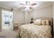 Comfortable bedroom with neutral walls, floral bedding, ceiling fan, and access to hall at 3502 Village Green Dr, Roswell, GA 30075