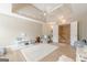 Bright bonus room featuring wood floors, tray ceiling, and a ceiling fan with decorative string lights at 3502 Village Green Dr, Roswell, GA 30075