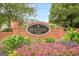 Well maintained Heritage at Roswell community sign surrounded by beautiful flower beds and greenery at 3502 Village Green Dr, Roswell, GA 30075