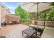 Outdoor wooden deck featuring comfortable lounge furniture and shaded by a patio umbrella at 3502 Village Green Dr, Roswell, GA 30075