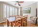Inviting dining room features a rustic wood table, comfortable seating, and bright natural light from the window at 3502 Village Green Dr, Roswell, GA 30075