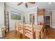 An alternate view of the dining room showcases hardwood floors, a painting, and the adjacent pantry area at 3502 Village Green Dr, Roswell, GA 30075