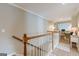 Upper level hallway with pristine white railings and a view of the light-filled home office at 3502 Village Green Dr, Roswell, GA 30075