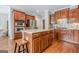 Spacious kitchen boasts stainless steel appliances, a center island with seating, and stylish wood cabinetry at 3502 Village Green Dr, Roswell, GA 30075