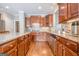 Stylish kitchen with granite countertops, wooden cabinetry, and stainless steel dishwasher at 3502 Village Green Dr, Roswell, GA 30075