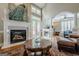 Elegant living room features a fireplace, high ceilings, an open layout, and cozy furnishings at 3502 Village Green Dr, Roswell, GA 30075