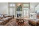 Inviting living room featuring a fireplace, tall windows, and comfortable seating creating a cozy atmosphere at 3502 Village Green Dr, Roswell, GA 30075