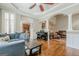 Open-concept living area with hardwood floors, archways, and comfortable blue sofa at 3502 Village Green Dr, Roswell, GA 30075