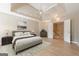 Tranquil main bedroom features a plush bed, soft lighting, and a convenient doorway to other rooms at 3502 Village Green Dr, Roswell, GA 30075