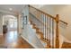 Classic staircase with carpeted steps, wood railings, and decorative iron spindles leading to the upper level at 3502 Village Green Dr, Roswell, GA 30075