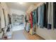 Spacious walk-in closet featuring custom shelving, hanging rods, and hardwood floors at 3502 Village Green Dr, Roswell, GA 30075