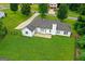 Aerial view of the backyard with a concrete patio and a large grassy area at 227 Ferguson Ave, Locust Grove, GA 30248