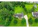 Aerial view of a lovely home on a large lot with mature trees and a well-maintained lawn at 227 Ferguson Ave, Locust Grove, GA 30248