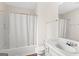 Bright bathroom features a shower-tub combo and white vanity with a large mirror at 227 Ferguson Ave, Locust Grove, GA 30248